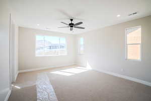 Unfurnished room featuring ceiling fan and light colored carpet