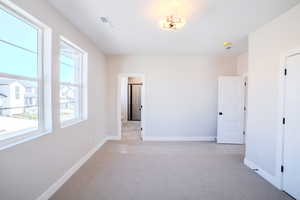 Spare room with light carpet and plenty of natural light