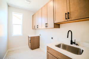 Laundry room featuring cabinets, sink, electric dryer hookup, light parquet flooring, and hookup for a washing machine