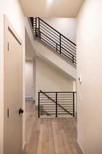 Staircase featuring wood-type flooring