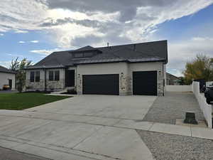 Prairie-style house with a front lawn and a garage