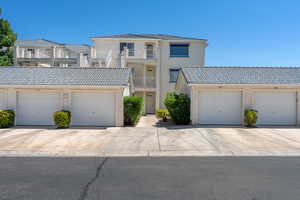 View of front of property with a garage and a balcony