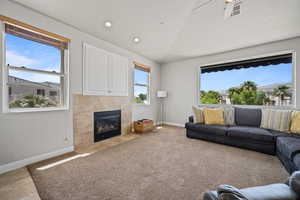 Living room with a fireplace and ceiling fan