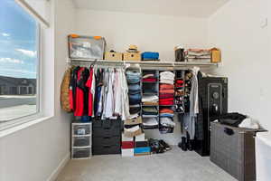 View of walk in closet connected to bathroom in the great room