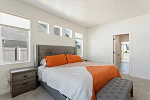 View of great room peering into bathroom and walk in closet