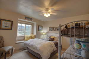 Bedroom featuring carpet and ceiling fan