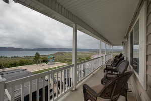 Balcony featuring a water and mountain view