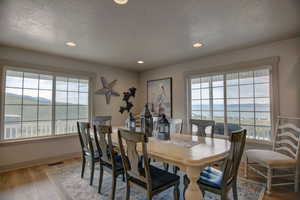 Dining room featuring a water view and light hardwood / wood-style flooring