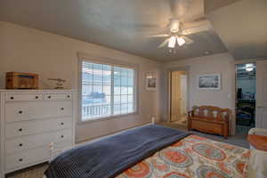 Carpeted bedroom with ceiling fan, a closet, and a spacious closet