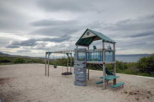 View of jungle gym featuring a water view