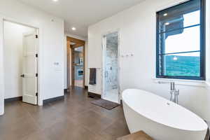 Bathroom with tile flooring and independent shower and bath