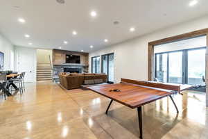 Game room featuring a stone fireplace