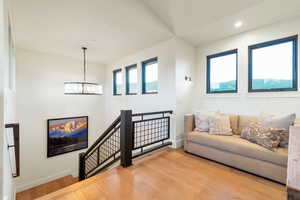 Living room with an inviting chandelier and light hardwood / wood-style flooring