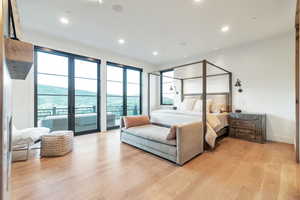 Bedroom with access to exterior and light wood-type flooring