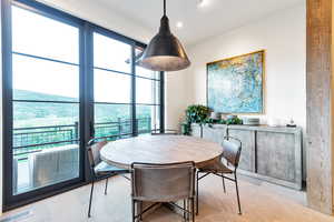 Dining space with a healthy amount of sunlight and light tile flooring