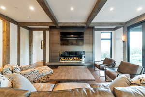 Living room featuring beam ceiling and hardwood / wood-style floors