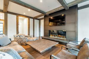 Living room featuring beam ceiling and hardwood / wood-style flooring