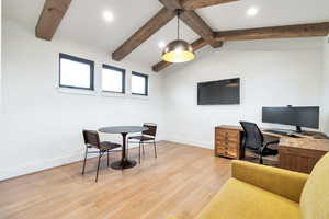 Office featuring light hardwood / wood-style floors and vaulted ceiling with beams