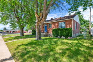 Ranch-style home featuring a front lawn