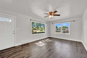 Entrance foyer featuring dark hardwood / wood-style floors and ceiling fan