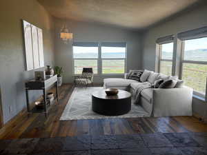 Living room featuring a healthy amount of sunlight, vaulted ceiling, and dark wood-type flooring