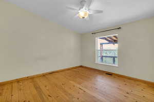 Unfurnished room with ceiling fan and light wood-type flooring