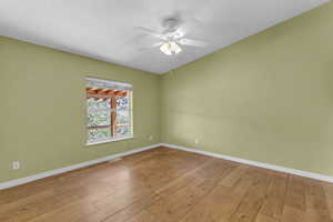 Spare room featuring wood-type flooring and ceiling fan