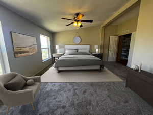 Bedroom featuring carpet flooring, ceiling fan, and a textured ceiling