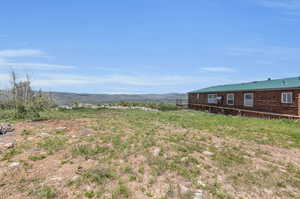 View of yard featuring a rural view and a mountain view