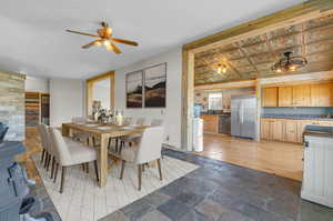 Dining room featuring ceiling fan and light tile floors