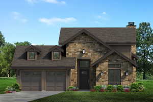 View of front of property featuring a garage and a front yard