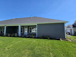 View of front facade with a front lawn and a garage