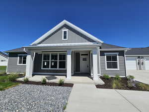 View of front of property featuring a garage and covered porch