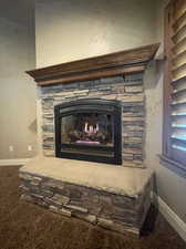 Interior details with a stone fireplace with wood mantle