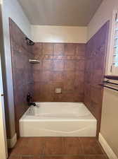 Bathroom with tiled shower / bath and tile flooring