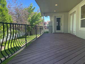 Deck featuring a lawn and mature landscaping