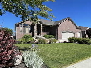 View of front of home featuring a garage and a front yard