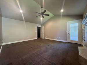 Primary bedroom featuring ceiling fan and vaulted ceiling with access to covered deck