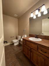 Bathroom with vanity, toilet, urinal and tile floors