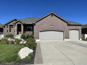 View of front of house featuring a garage and a front yard