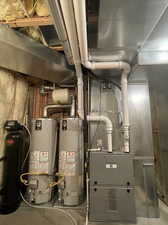 Utility room featuring 96% 2 stage, variable speed furnace, two 40 gallon water heaters and soft water system