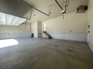 Garage featuring a garage door opener, garage heater, central vacuum hook ups, utility sink & salt tank for soft water system