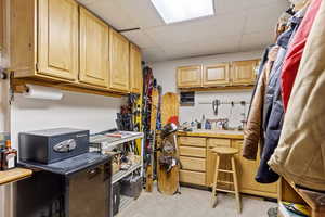 Spacious closet featuring a workshop area and a paneled ceiling