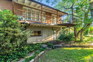 Back of property with a balcony