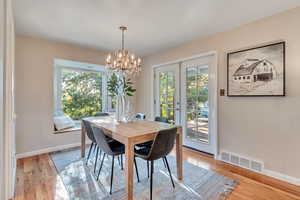 Dining space featuring a healthy amount of sunlight, french doors, and light wood-type flooring