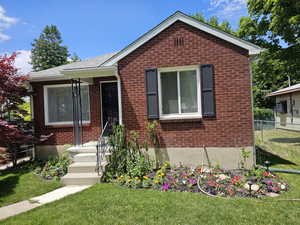 Bungalow-style house featuring a front lawn