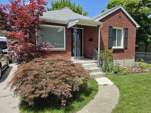 Bungalow-style house with a front lawn