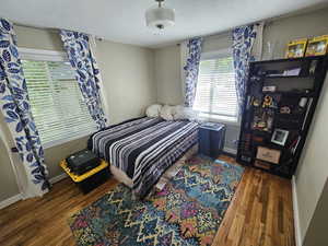 Bedroom with dark wood-type flooring