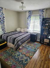 Bedroom with hardwood / wood-style flooring