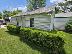 View of side of property featuring a lawn